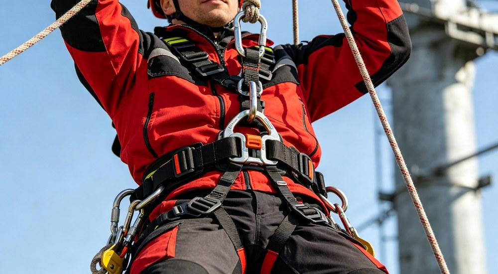 Rescue worker using full body harness for vertical rope rescue operation