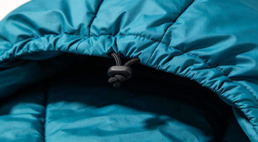 Close up of sleeping bag hood and drawstring detail, head coverage design feature, product macro photography, quality craftsmanship